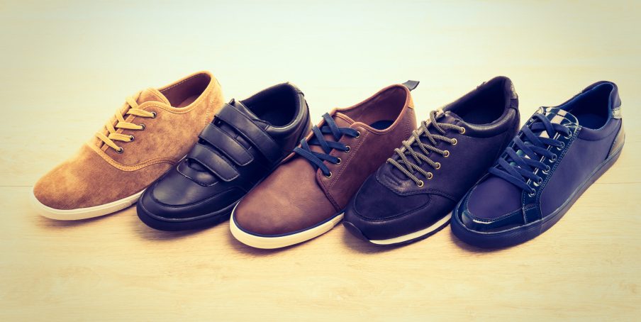 Beautiful many leather shoes for men on wooden background - Vintage light Filter processing